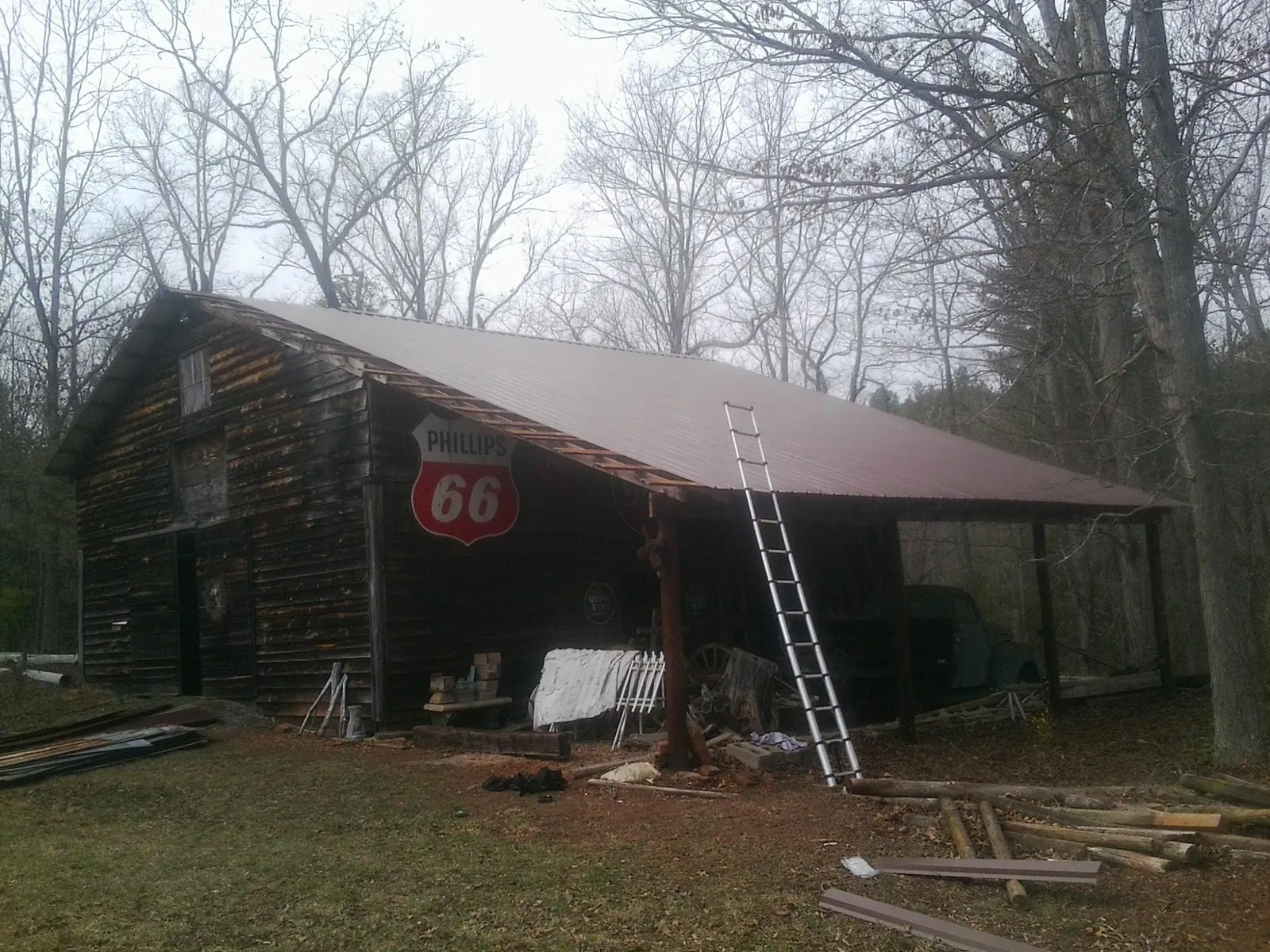New metal roof on an open sided timber barn with a vintage sign in Scott
